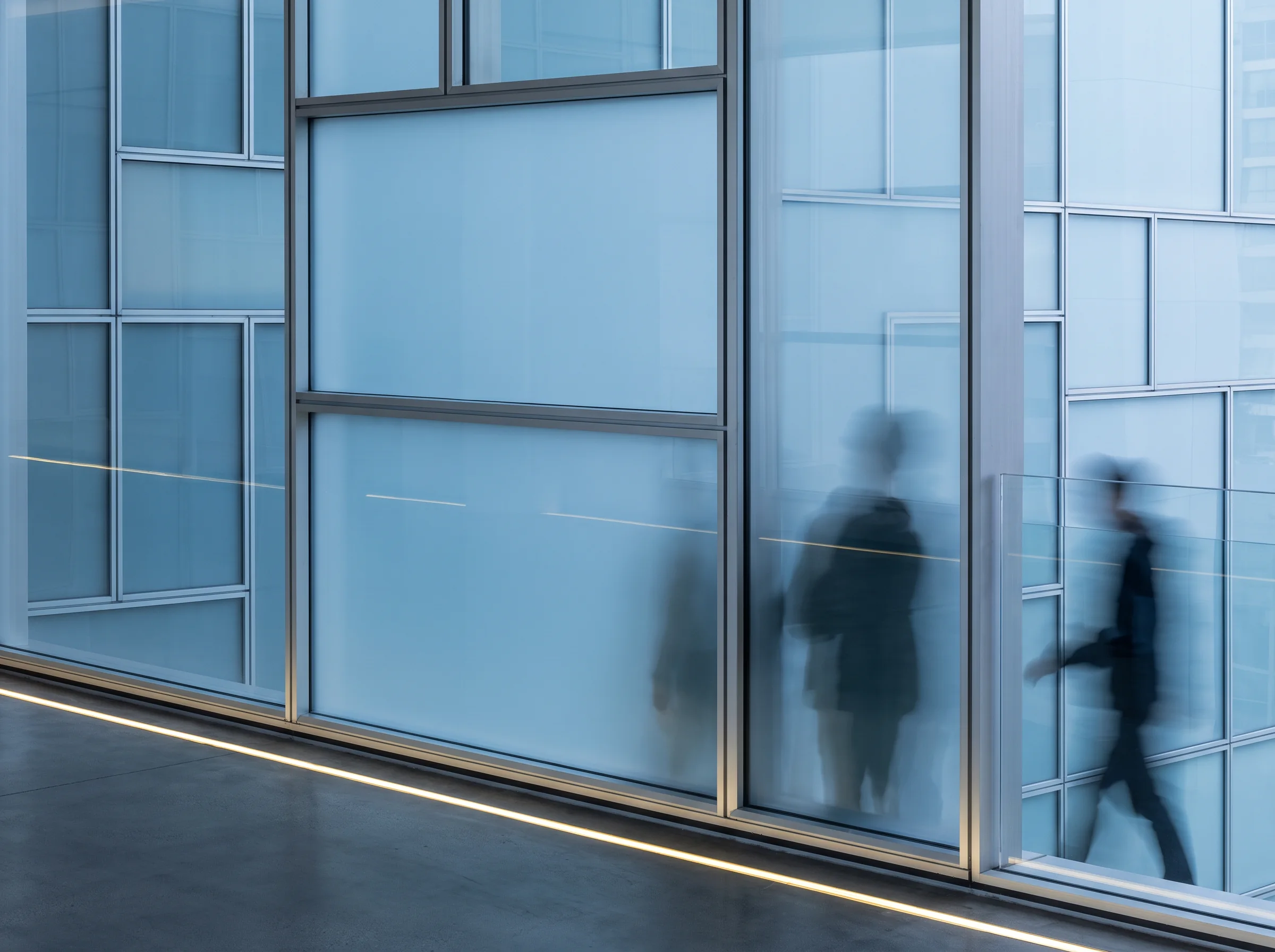 People seen moving behind frosted glass